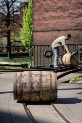 Download A picture of a Buffalo Trace Distillery employee rolling barrels intended for media kit usage